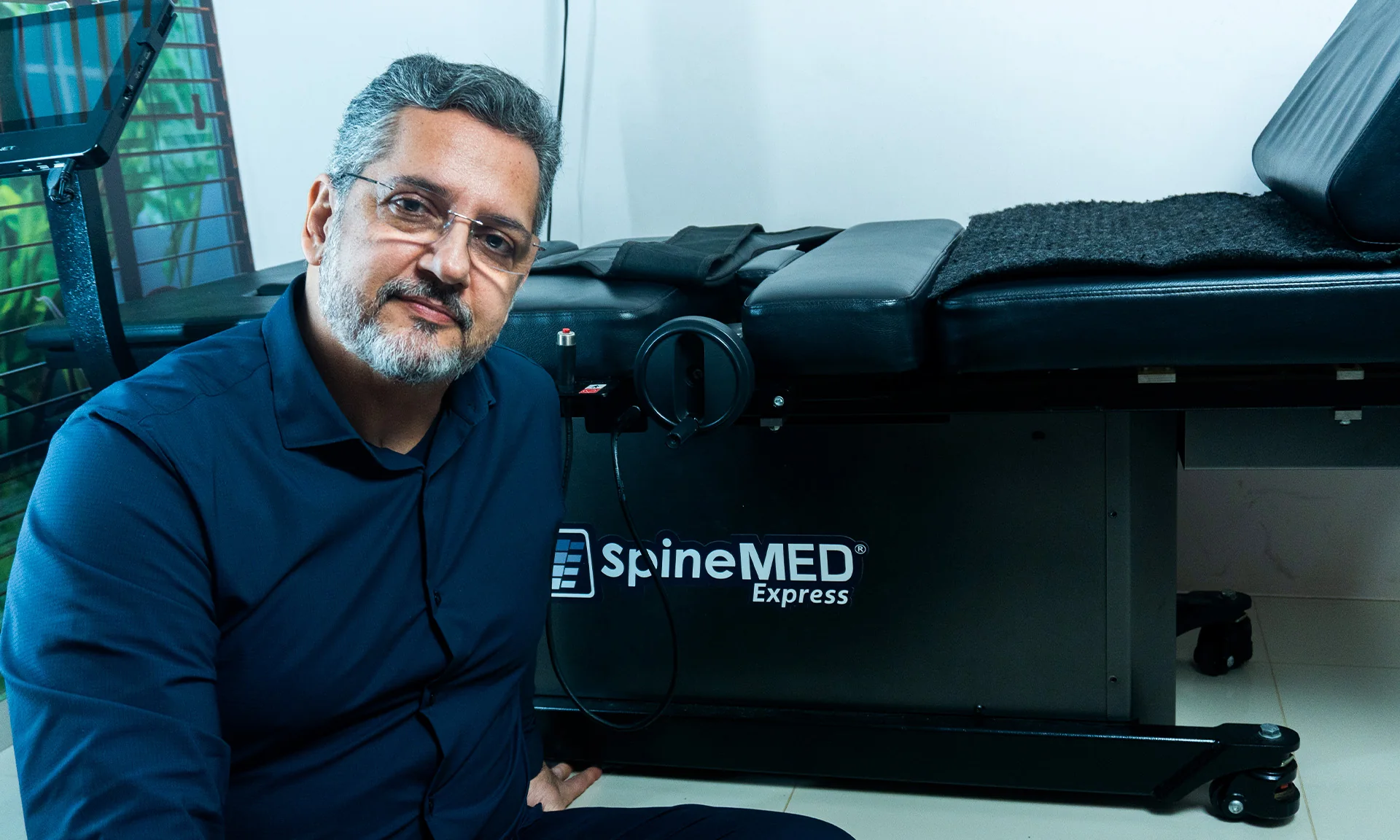 Dr. Vladmir Resende ao lado do equipamento SpineMED para tratamento da coluna